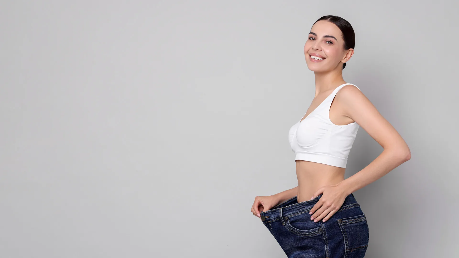 Woman celebrating weight loss results at iCRYO Guilderland Medical Weight Loss program
